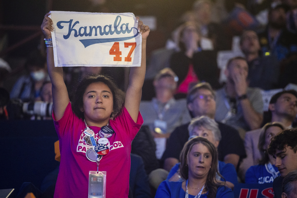 A person holds a "Kamala 47" sign during the third night of the Democratic National Convention.