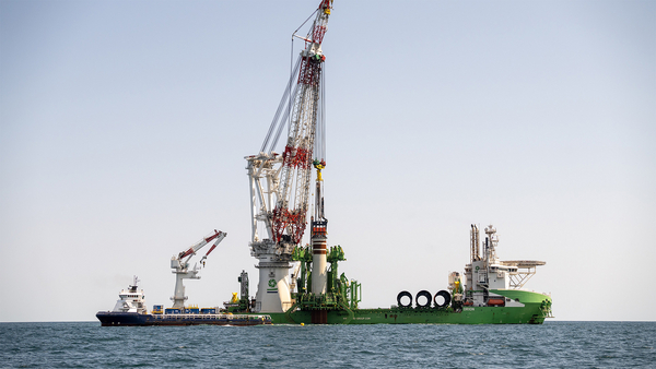 The Dutch heavy lift vessel Orion places offshore wind turbine foundations off the coast of Virginia.