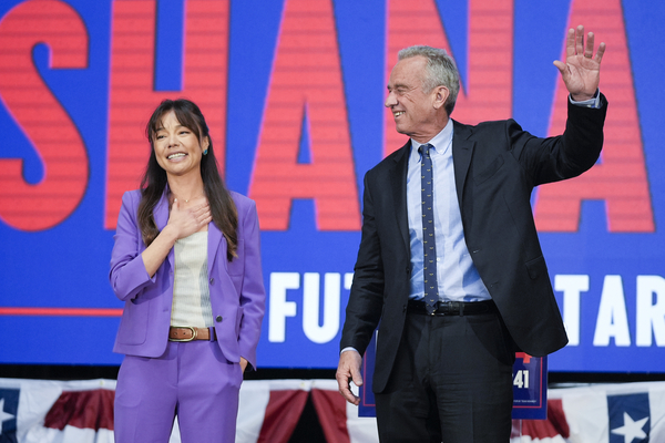 Presidential candidate Robert F. Kennedy Jr. waves on stage with Nicole Shanahan after announcing her as his running mate.