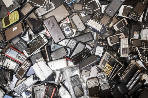 Discarded mobile phones fill a bin at the Out of Use company warehouse in Beringen, Belgium.