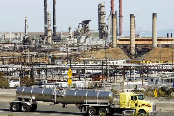 A tanker truck passes the Chevron oil refinery.