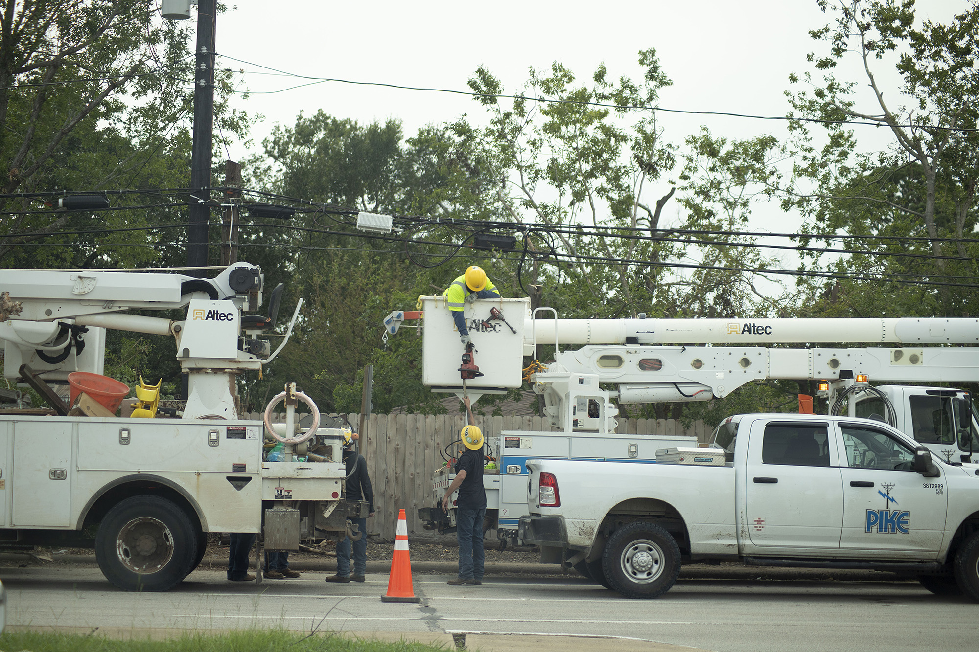 A crew works on damaged powerlines in Houston, July 14, 2024.