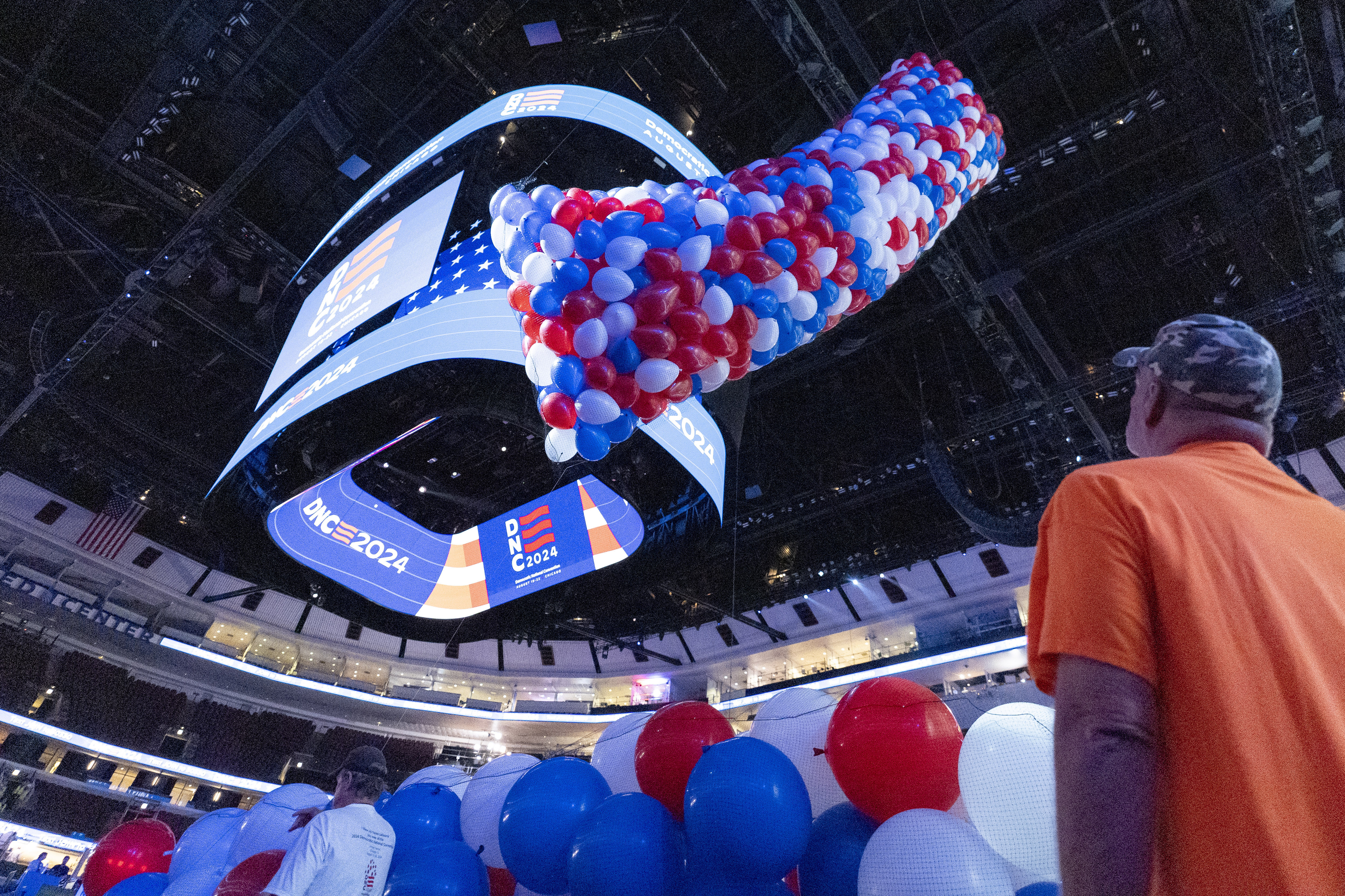 A bag of balloons is raised to the ceiling as preparations are made before the upcoming Democratic National Convention.