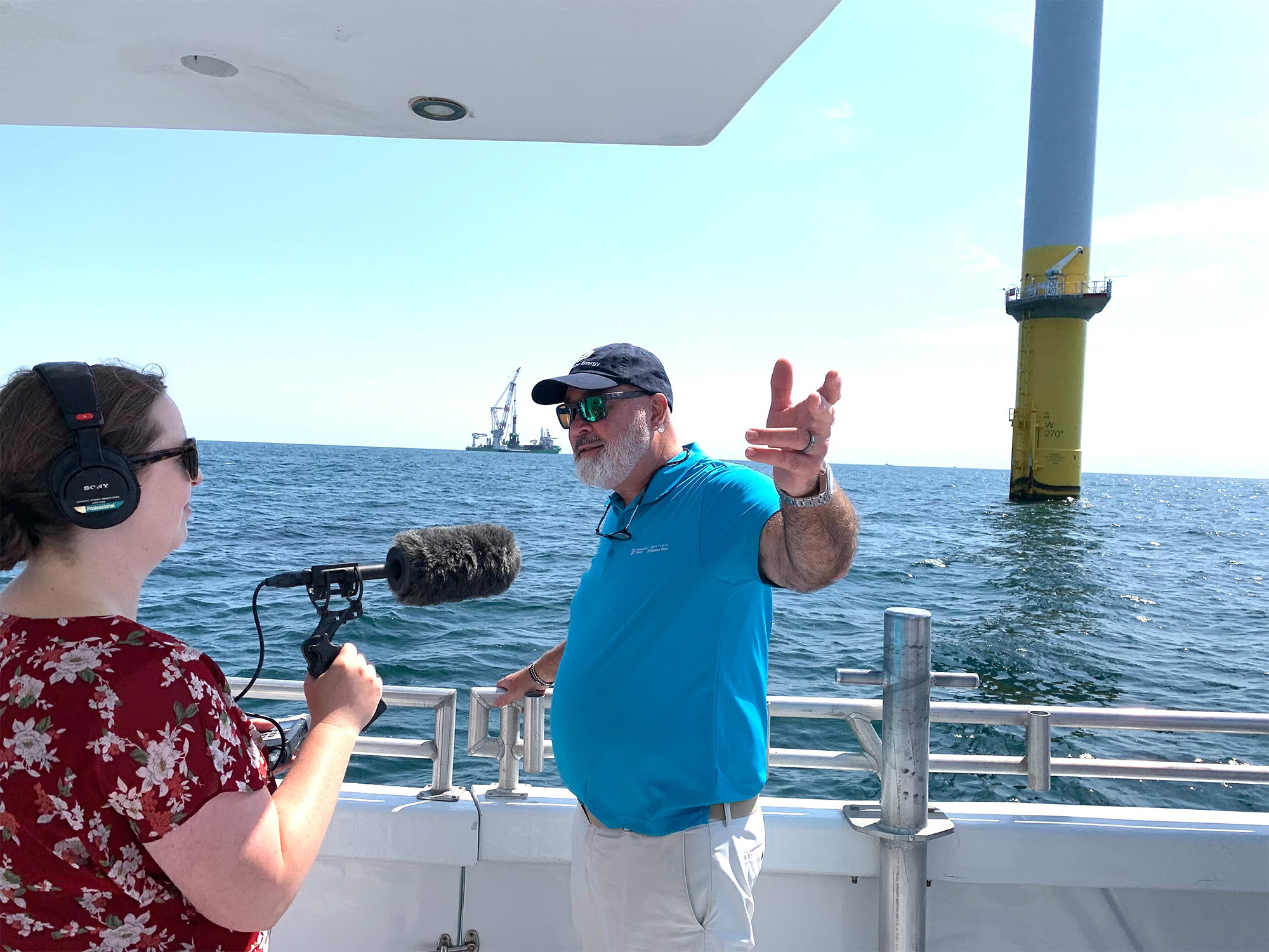 Dominion Energy’s John Larson speaking to a radio reporter during construction of the company’s 176-turbine wind farm this summer.