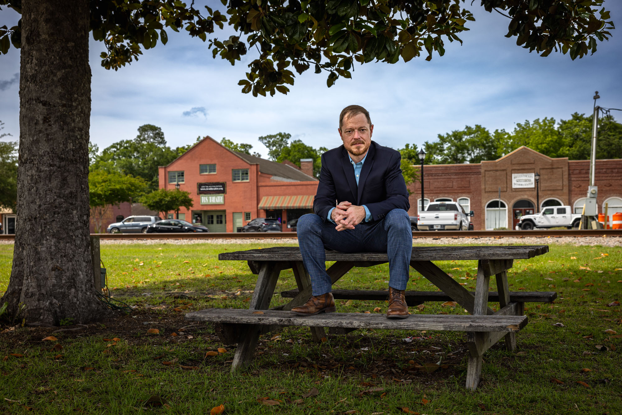 Chris Benson is pictured sitting on top of a picnic table.